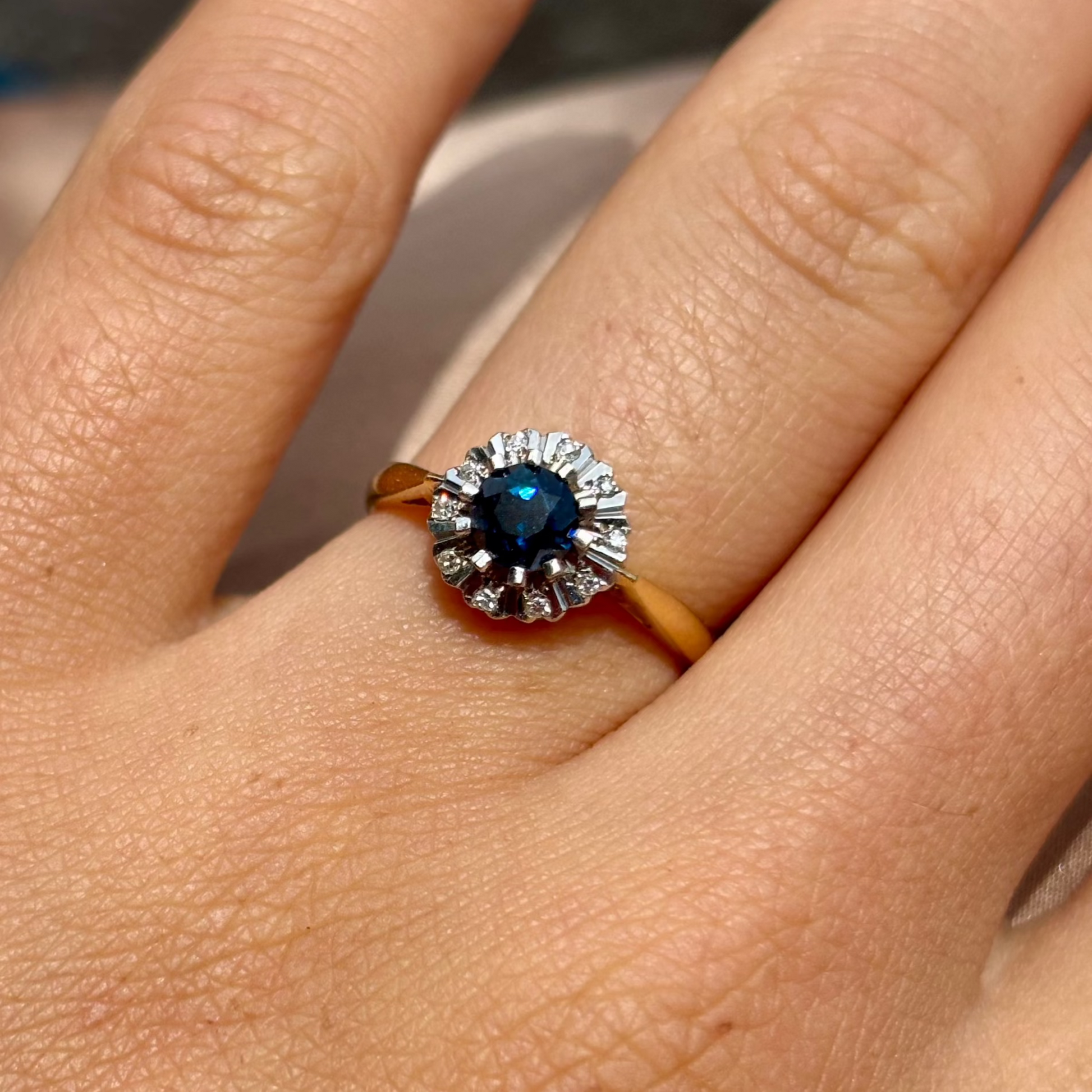 Ring with a blue gemstone on a finger