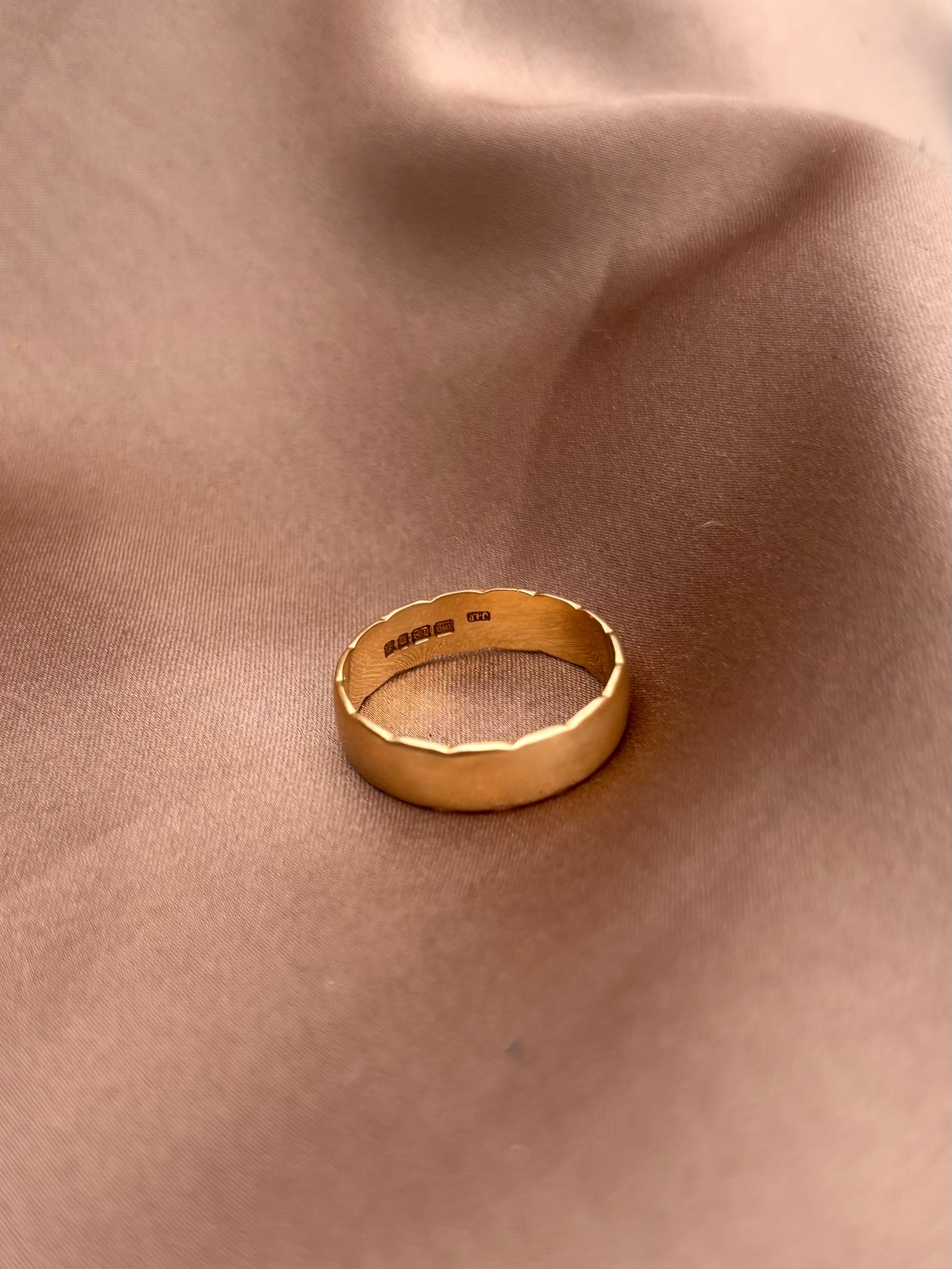 Gold ring on a beige fabric background